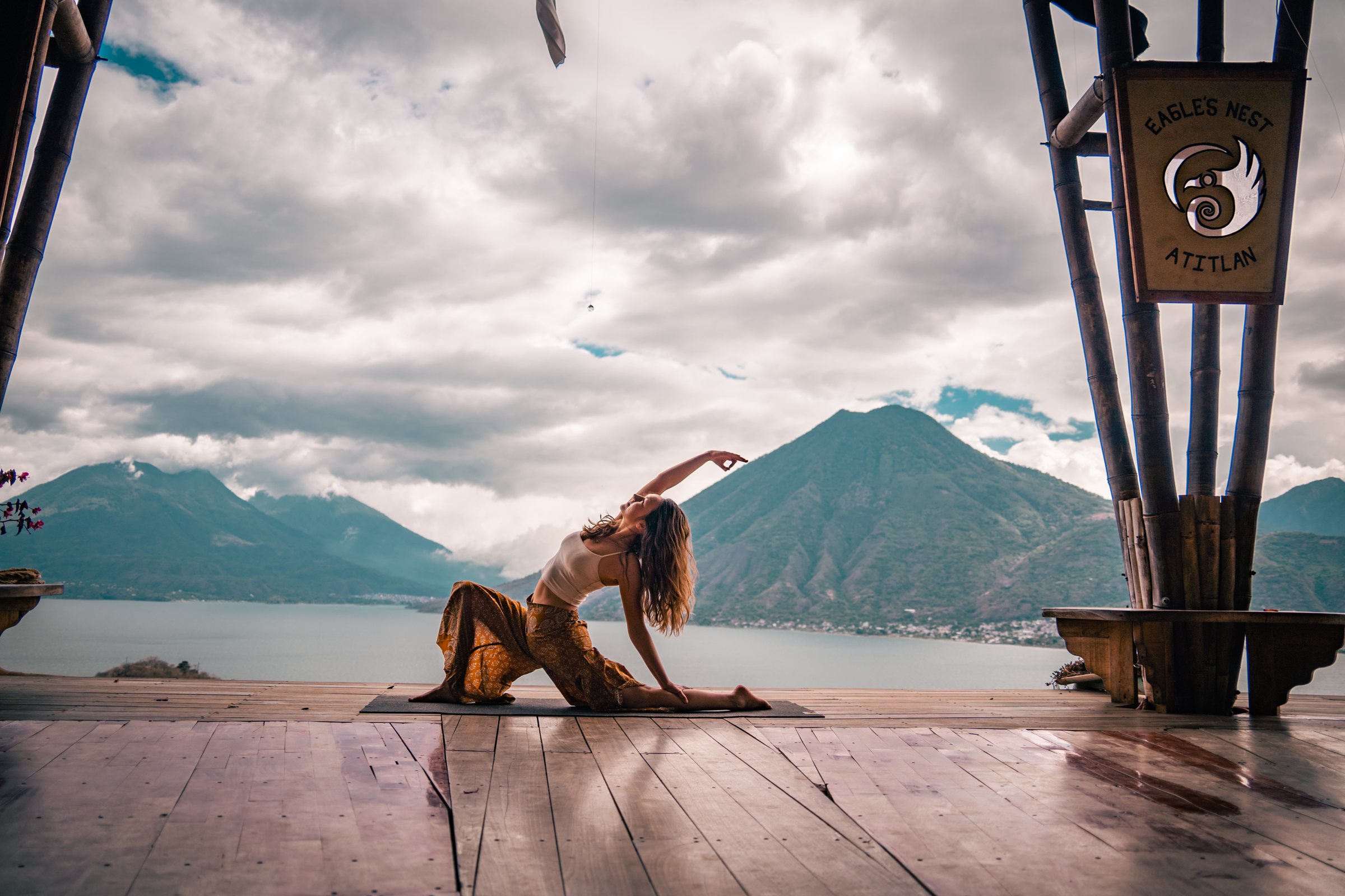 Woman in a seated yoga pose overlooking Lake Atitlán at Eagle's Nest Atitlán